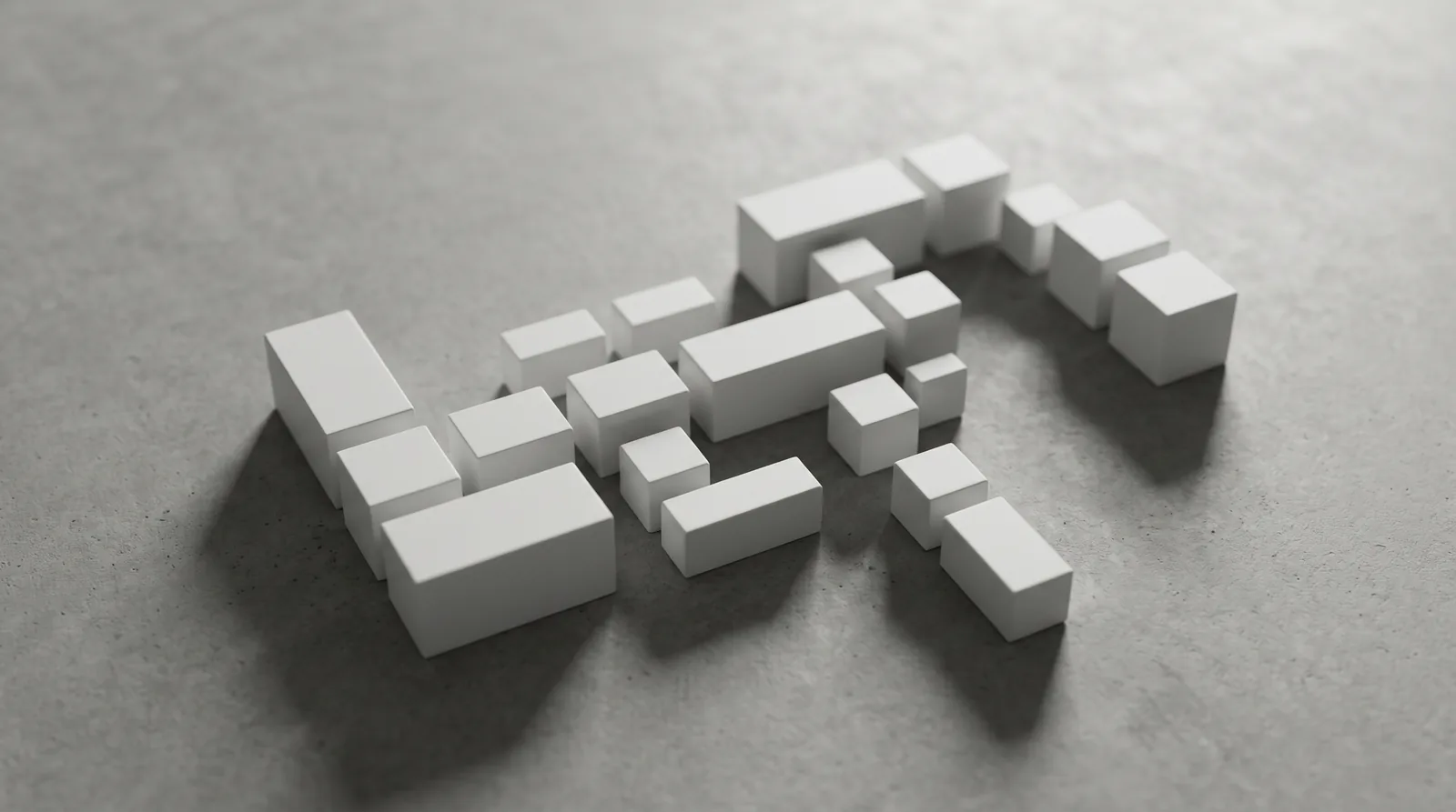 Assemblage minimaliste de petits blocs blancs modulaires sur surface grise béton, métaphore visuelle de la doctrine produit assemblée par l'utilisateur